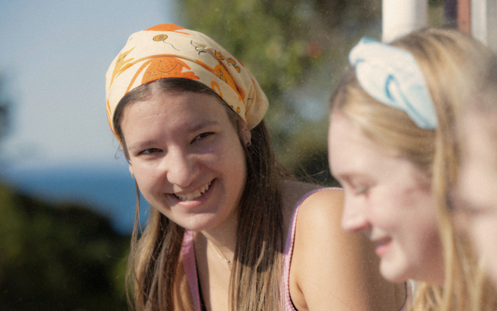 two young people wearing cancer charity bandannas from canteen