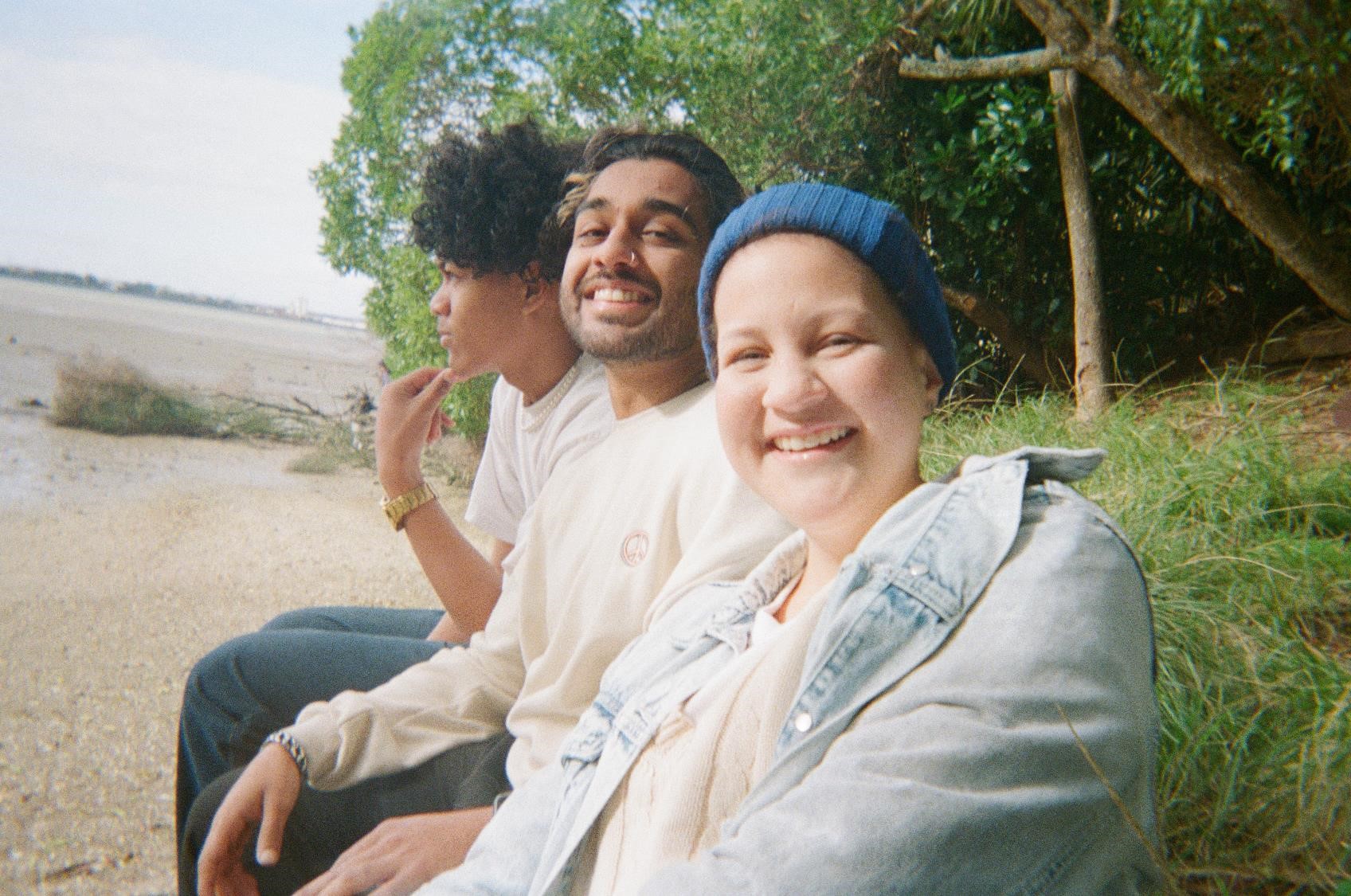 three young people impcated by cancer smiling